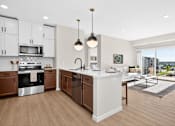 Thumbnail 3 of 19 - A modern kitchen with wooden floors and white walls.