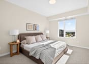 Thumbnail 7 of 19 - A bedroom with a large bed and a window overlooking a cityscape.