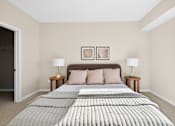 Thumbnail 8 of 19 - A bed with a grey comforter and two pillows is in the center of the image.