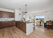 Thumbnail 13 of 25 - A modern kitchen with wooden floors and a large island.