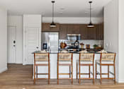 Thumbnail 16 of 25 - A kitchen with a bar stool in front of the island.
