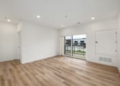 Thumbnail 50 of 61 - A room with wooden flooring and white walls.