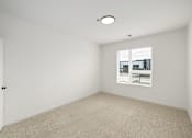 Thumbnail 52 of 61 - A white room with a window and a carpet on the floor.