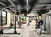 Thumbnail 42 of 61 - A gym with a variety of equipment including weightlifting machines and a bench.