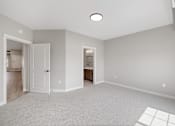 Thumbnail 28 of 76 - A spacious room with a carpeted floor and a ceiling light.