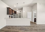 Thumbnail 35 of 39 - A kitchen with a white counter and brown cabinets.