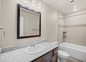 Thumbnail 38 of 39 - A bathroom with a sink, toilet, and bathtub.
