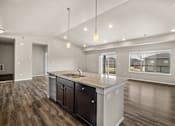 Thumbnail 27 of 39 - A modern kitchen with dark wood floors and a large island.