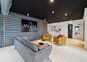 Thumbnail 35 of 88 - A room with a sofa and two lounge chairs and sign that says The Ascent.
