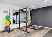 Thumbnail 52 of 88 - A gym with a weight lifting area.