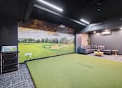 Thumbnail 41 of 88 - A golf simulator room with a mural of a golf course.