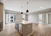 Thumbnail 55 of 88 - A kitchen with island and brown cabinets.