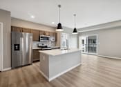 Thumbnail 61 of 88 - A kitchen with island and brown cabinets.