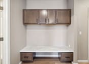 Thumbnail 69 of 88 - A boot bench with cabinets above.
