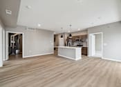 Thumbnail 59 of 88 - A kitchen with island and brown cabinets.