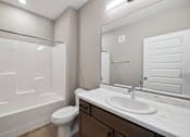 Thumbnail 67 of 88 - A bathroom with wood toned vanity