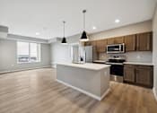 Thumbnail 57 of 88 - A kitchen with island and brown cabinets.