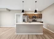 Thumbnail 56 of 88 - A kitchen with island and brown cabinets.