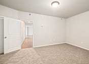 Thumbnail 50 of 64 - A room with a carpeted floor and a white door.