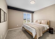 Thumbnail 13 of 61 - A bedroom with a large bed and a window overlooking the ocean.