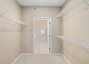 Thumbnail 15 of 61 - A room with a white door and a carpeted floor.