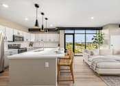Thumbnail 10 of 61 - A modern kitchen with a large island and a dining area with a view.