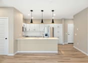 Thumbnail 33 of 61 - A kitchen with a white counter and cabinets.