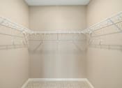 Thumbnail 30 of 61 - Empty white walk in closet with shelves.