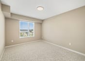 Thumbnail 25 of 61 - A room with a window overlooking a cityscape.