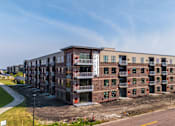 Thumbnail 2 of 61 - A large building under construction with a clear blue sky above.