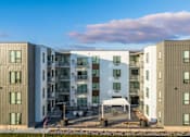 Thumbnail 72 of 88 - an image of an apartment building with a blue sky in the background