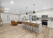 Thumbnail 14 of 88 - an open kitchen and living room with an island and bar stools