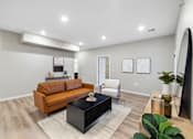 Thumbnail 15 of 88 - a living room with a leather couch and a coffee table