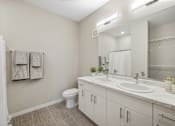 Thumbnail 18 of 88 - a bathroom with a large mirror and a toilet and sink
