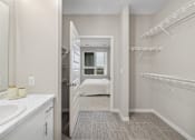 Thumbnail 20 of 88 - a bathroom with a sink and a mirror and a walk in closet