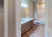Thumbnail 18 of 19 - A bathroom with a toilet, sink, and mirror.