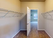 Thumbnail 16 of 19 - A room with a white door and two metal racks on the wall.