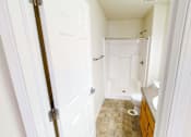 Thumbnail 12 of 17 - A bathroom with a toilet, sink, and bathtub.