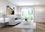 Thumbnail 3 of 4 - A living room with a white couch, a painting on the wall, and a potted plant.