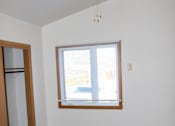 Thumbnail 18 of 18 - A room with a ceiling fan and a window with blinds.