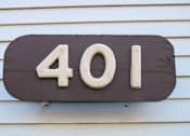 Thumbnail 17 of 18 - A brown house number sign with the number 401 on it.