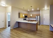 Thumbnail 8 of 19 - A kitchen with a wooden island and stainless steel appliances.