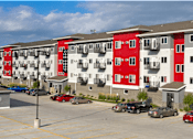 Thumbnail 6 of 19 - Apartment building with red and white balconies.