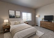 Thumbnail 5 of 36 - A bedroom with a large bed, a TV, and two framed pictures on the wall.