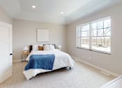 Thumbnail 10 of 15 - A bedroom with a bed, pillows, and a blanket.