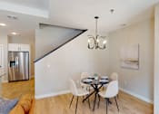 Thumbnail 8 of 15 - A dining room with a table set for two.