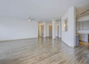 Thumbnail 23 of 30 - A room with wooden floors and white walls.