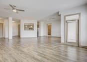 Thumbnail 13 of 30 - A spacious room with a ceiling fan and lighting fixture.