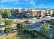 Thumbnail 1 of 30 - A roundabout in a city with buildings around it.