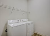 Thumbnail 30 of 30 - A white washer and dryer in a laundry room.